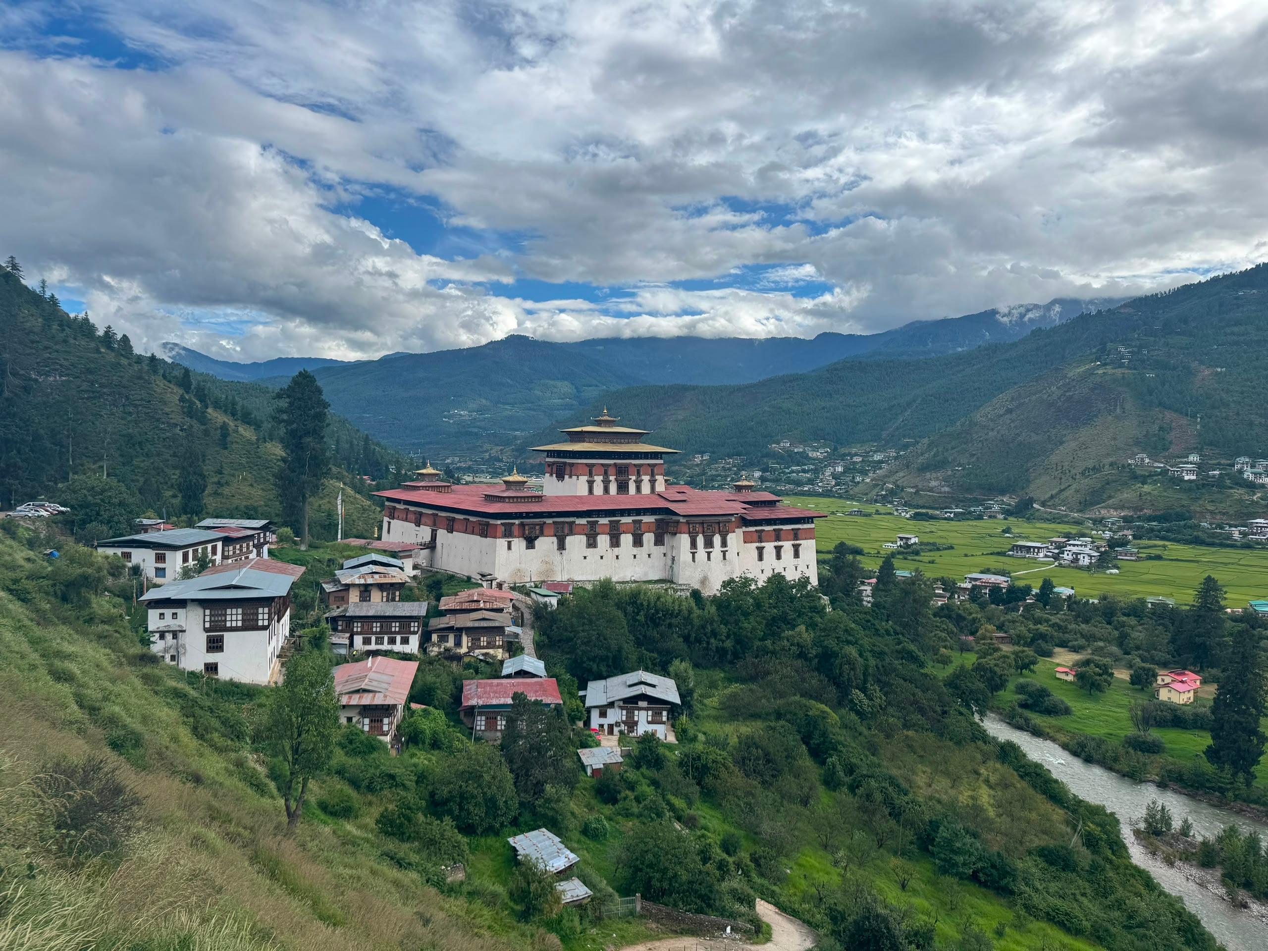 Rinpung Dzong overlooking green fields and the Paro Valley